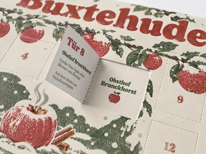 Tür 8: eine Tüte Äpfel vom Obsthof Brunckhorst, hinten der Gutschein, im Fenster der Partner